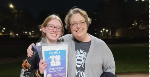 Smiling together, junior Kaitlin Brummer and choir director Karen Paul celebrate advancing to state.